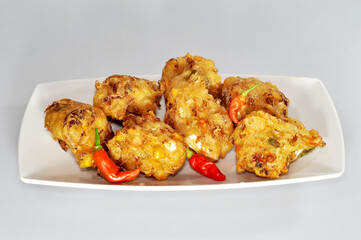 Bakwan is a food from Indonesia made from wheat flour and combined with bean sprouts, cabbage, carrots and corn and fried.