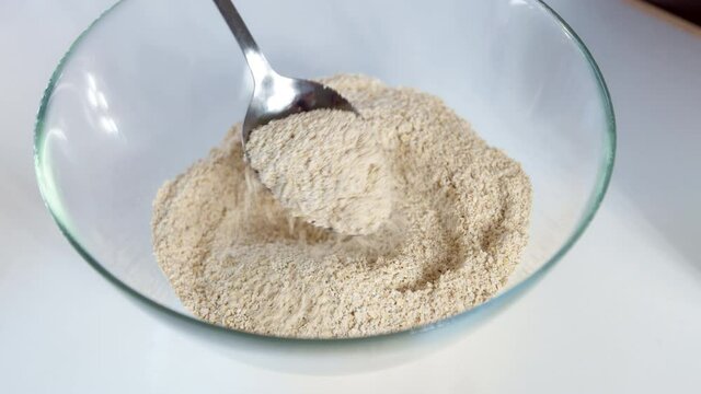 Spoon oat flour into a plate.