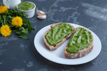 Pesto sauce sandwich with on rye bread. Dandelions pesto and sandwiches - delicious snacks, appetizers, tapas