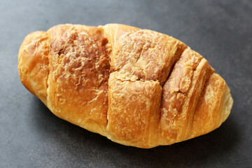 Delicious fresh croissant on a black background