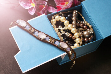 A set of jewelry in a jewelry box, a bracelet with pink stones