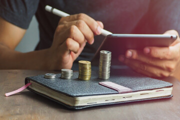 business person using a tablet computer to make a profit plan  Money saving ideas for financial accounting