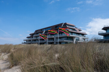 Obraz premium Yellow sandy beach in small Belgian town Knokke-Heist, luxury vacation destination, summer holidays