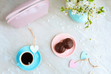 spring flat lay good morning cup of coffee and chocolate covered cookies