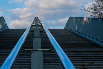 Partial view of an outdoor stairs from a pedestrian bridge in Maastricht, creating an  conceptual view of a daily life construction work.