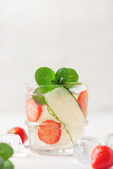 Summer refreshing iced drinks with cucumber,  strawberry and mint on white background