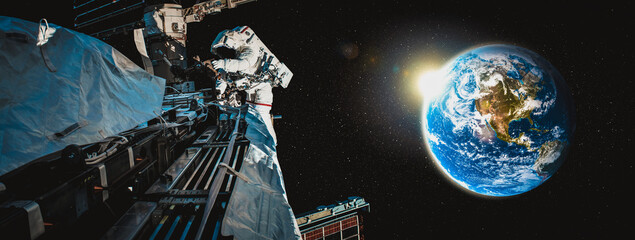 Astronaut spaceman do spacewalk while working for space station in outer space . Astronaut wear full spacesuit for space operation . Elements of this image furnished by NASA space astronaut photos. © InfiniteFlow