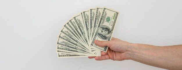 Hands holding a one hundred dollars bill . Hands holding a lot of money . Isolated on white background