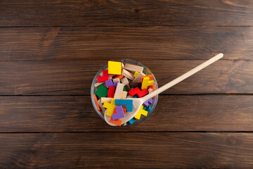 Creative idea concept - wooden puzzle in bowl with spoon. Develop new idea, food for inspiration.