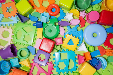 Childrens toys, blocks and puzzles on a green background top view. Preschool education.