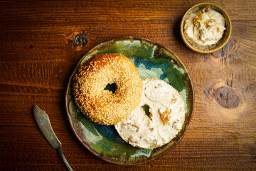 Sourdough sesame seed bagel with honey walnut fig cream cheese