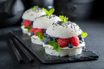 Delicious sush burger with blueberries and raspberries sprinkled with sesame.
