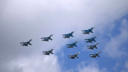 Fototapeta na wymiar MOSCOW, RUSSIA - MAY 7, 2021: Avia parade in Moscow. su-35 and su-34 and su-30 in the sky on parade of Victory in World War II in Moscow, Russia