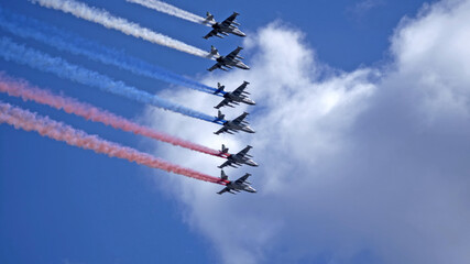 MOSCOW, RUSSIA - MAY 7, 2021: Avia parade in Moscow. Group of Russian fighters Sukhoi Su-25 with painted russian flag in the sky on parade of Victory in World War II in Moscow, Russia