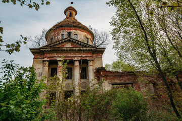 Old ancient abandoned church ruins overgrown by plants