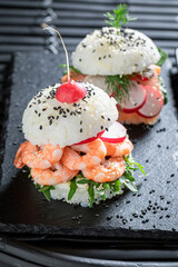 Tasty sush burger with rice and seafood as Japanese appetizers.