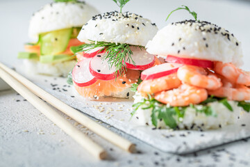 Delicious sush burger with rice and seafood sprinkled with sesame.
