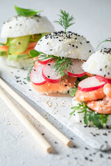 Healthy sush burger with rice and seafood as Japanese appetizers.