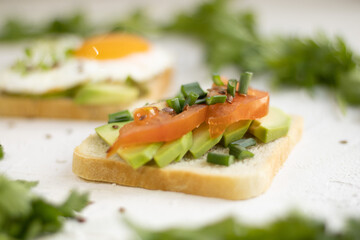 Healthy snack. Snack with avocado and tomato. Bruschetta with tomatoes, avocado and radish.