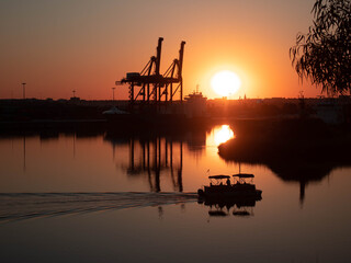 Boat passing through a sunset