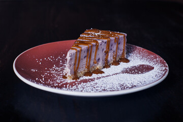 sweet dessert cake on a plate, beautiful serving, dark background