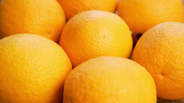 Ripe Fresh Orange Oranges, Rotation, Close-up. Harvest Of Ripe Oranges. Background of Oranges, Cirtus Fruits. Oranges on the Market.
