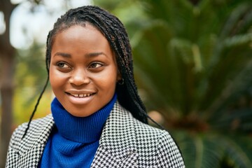 Young african american businesswoman smiling happy standing at the park.