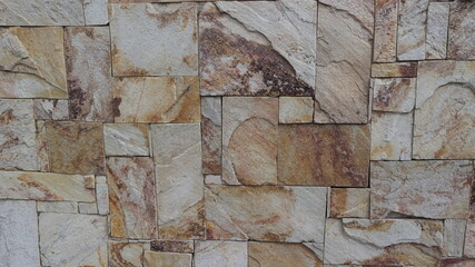 The background is made of beautiful gray facing stone with orange veins.
