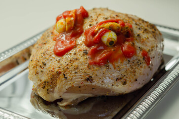 Prepared meat for Halloween party, raw chicken crown with a salt and pepper seasoning and peppercorn butter