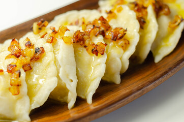 Close up of dumplings sprinkled with fried onion, traditional Polish, Russian and Ukrainian cuisine
