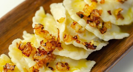 Close up of dumplings sprinkled with fried onion, traditional Polish, Russian and Ukrainian cuisine