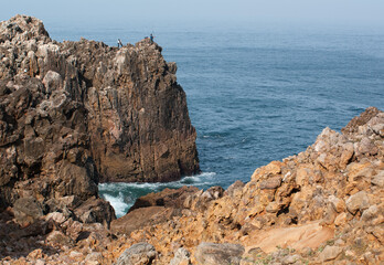 Fototapeta na wymiar Fishing on rocky shores, Algarve