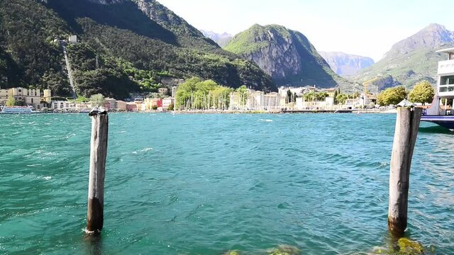 Riva del Garda beach with lake at sunrise. View of Lake Garda, Riva del Garda,Italy. Popular destinations for travel in Europe. Lake Garda view in the picturesque town of Riva del Garda. 