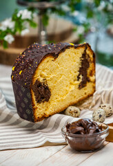 Home Made Panettone. Traditional Italian sweet bread. Panettone with a slice served on a wooden table.