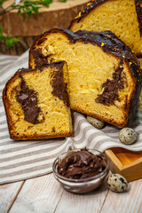 Home Made Panettone. Traditional Italian sweet bread. Panettone with a slice served on a wooden table.