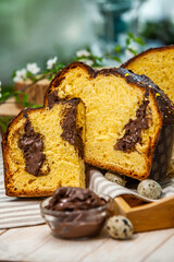 Home Made Panettone. Traditional Italian sweet bread. Panettone with a slice served on a wooden table.