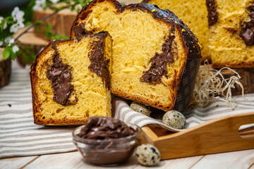 Home Made Panettone. Traditional Italian sweet bread. Panettone with a slice served on a wooden table.