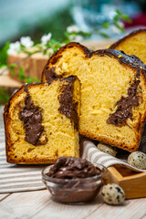 Home Made Panettone. Traditional Italian sweet bread. Panettone with a slice served on a wooden table.