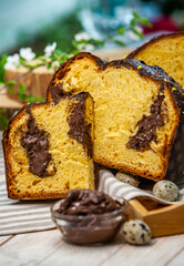 Home Made Panettone. Traditional Italian sweet bread. Panettone with a slice served on a wooden table.