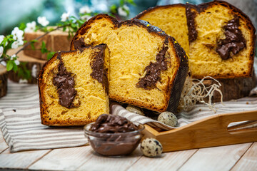 Home Made Panettone. Traditional Italian sweet bread. Panettone with a slice served on a wooden table.