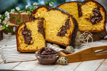 Home Made Panettone. Traditional Italian sweet bread. Panettone with a slice served on a wooden table.