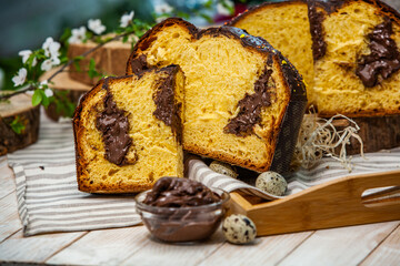 Home Made Panettone. Traditional Italian sweet bread. Panettone with a slice served on a wooden table.