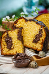 Fototapeta na wymiar Home Made Panettone. Traditional Italian sweet bread. Panettone with a slice served on a wooden table.