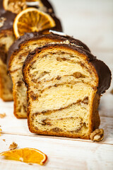 Home Made Panettone. Traditional Italian sweet bread. Panettone with a slice served on a wooden table.
