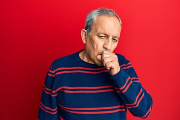 Senior hispanic man wearing casual clothes feeling unwell and coughing as symptom for cold or bronchitis. health care concept.