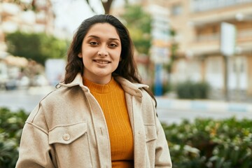 Young middle east woman smiling happy standing at the city.