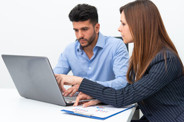 Business people using a laptop computer in their office