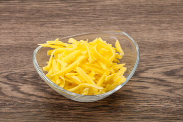 Shredded yellow cheese in the bowl