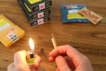 Winnipeg, Manitoba / Canada - June 12, 2018: Legal Weed Products. Close-up of Hands, Lighter and Joint. 
