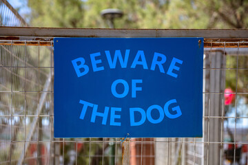 Beware of the dog, message on blue sign background.